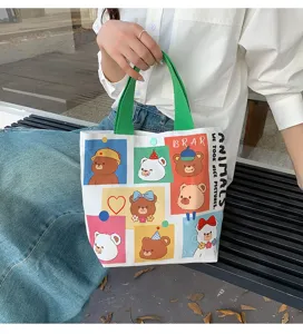 Cute cartoon bear print canvas tote bag, perfect for daily commuting and lunch storage.