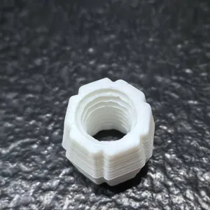 Close-up detail view of the internal threads of white 3D printed plastic adapter.