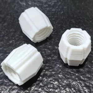 Closeup of white 3D printed toothpaste dispenser converter replacement parts, detail view.