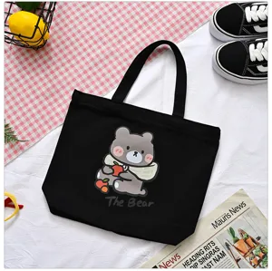 Black canvas tote bag with cute bear graphic, casual daily handbag for women and girls shopping.