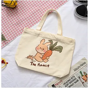 Cute cartoon rabbit print canvas tote bag detail view, soft fabric and sturdy double handles.