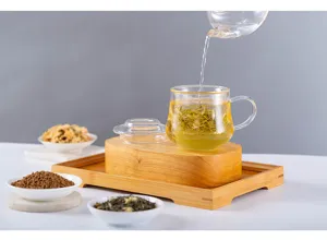 High borosilicate glass teacup with infuser and wooden base minimalist office tea set.