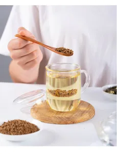 High borosilicate glass tea cup with infuser and wooden coaster for office home use.