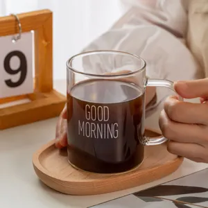 Clear glass coffee mug with handle and wooden saucer, ideal for daily warm morning use.