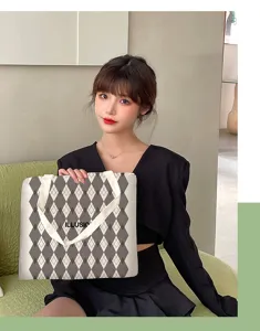 Detail view of a large capacity argyle canvas tote bag with double handles for daily use.