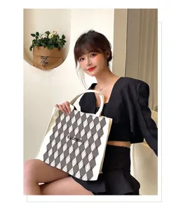 Detailed view of large canvas tote bag with argyle pattern and ILLUSION print for daily use