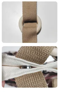 Canvas tote bag detail view showing sturdy brown webbing, wooden ring and magnetic snap.