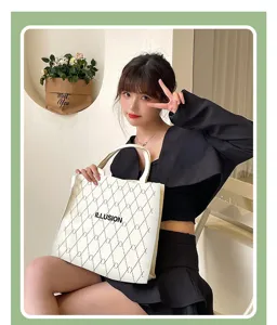 Detailed view of the stylish white canvas tote bag with chic diamond grid pattern and text print.