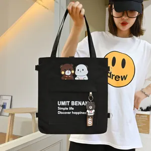 Black canvas tote bag with cute cartoon bear patches and stylish letters for daily use.