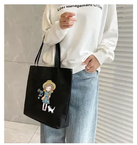 Black canvas tote bag for women, large capacity casual shoulder bag with cute cartoon print.