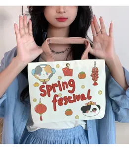 Canvas tote bag detail showing cute cartoon prints like cat and panda with Spring Festival theme.