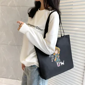 Large capacity black canvas tote bag with cute cartoon girl print for women daily commute.