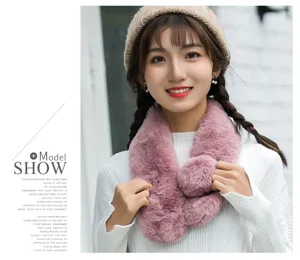 Detail view of a soft fluffy plush winter scarf worn by a model, cozy and warm texture.