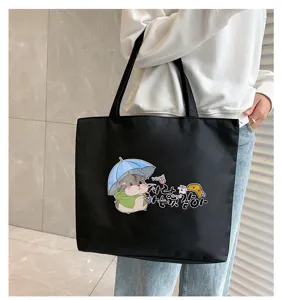 Black canvas tote bag with cute hamster graphic print, spacious casual shoulder bag for daily use.