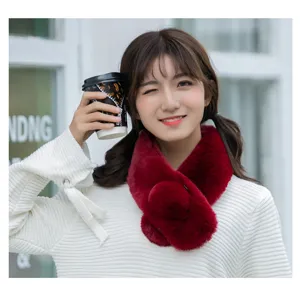 Detailed view of the plush red cross scarf, showing soft fluffy texture and cute design.