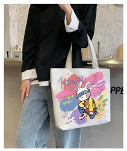 Detail shot of a casual canvas tote bag featuring graffiti rabbit print and spacious design.