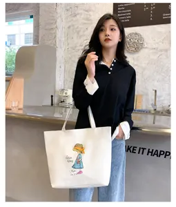 Detailed shot of large capacity canvas tote bag with cute cartoon girl print for women and students.