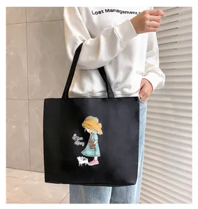 Detailed view of casual black canvas tote bag with cute girl illustration for daily commuting.