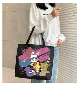 Detail view of large capacity black canvas tote bag with trendy graffiti rabbit print.