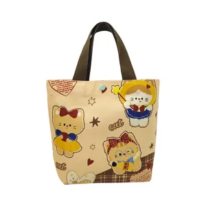 Cute canvas tote bag with cartoon cat print, versatile handbag for women commuting and lunch.