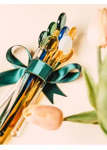 Detailed shot of heat-resistant glass stirring rods in multi colors, perfect for drinks.