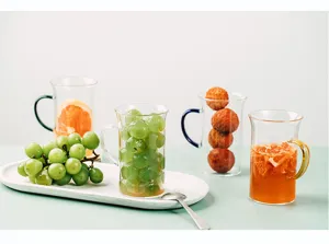 Clear heat-resistant glass cup with colorful handle for breakfast milk, coffee, or tea.