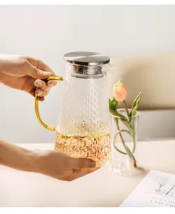 Heat-resistant glass teapot with hammer texture, gold handle and steel infuser for home use.