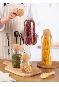 Glass storage jar detail showing clear borosilicate glass and natural round cork lid for dry food.