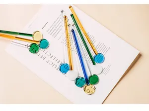 Detailed shot of colorful heat-resistant glass stirring rods arranged on a magazine for drinks.