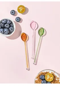 Colorful glass spoons detail shot, cute candy colored stirring spoon for desserts.