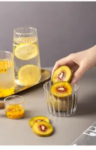 Gedetailleerd overzicht van de transparante geribbelde glazen beker met fruit.
