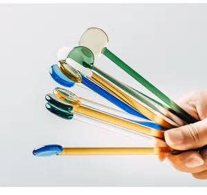 Japanese heat-resistant glass stirring rod detail showing colorful long handle dessert spoons