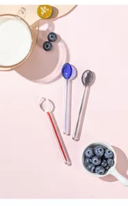 Detailed view of colorful glass mixing spoons showcasing delicate handle design for desserts.