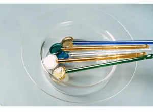 Clear heat-resistant glass stirring rod set for coffee juice and dessert mixing detail.