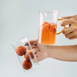 Clear heat-resistant glass cup with golden handle square design for coffee milk tea drinks.