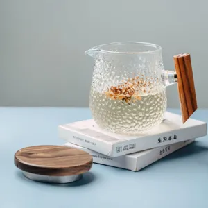 Japanese glass tea cup with wooden handle and lid, minimalist clear brew pitcher for office.