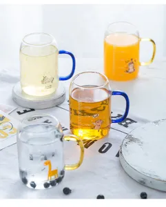 Clear glass measuring mug with cute cartoon animal print and colorful handle for kids.