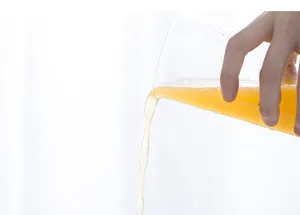 Clear glass cup detail showcasing graduation scale and liquid pouring for daily use.