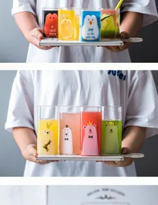 Cute square glass water cup with cartoon penguin and bear designs for kids daily drinking use.