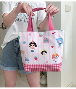 Pink striped canvas tote bag with cute cartoon prints and sturdy handles, perfect daily lunch bag.