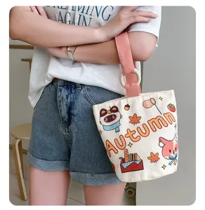 Cute canvas bucket handbag for women, casual commuting straight tote bag with print.