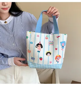 Cute striped canvas tote bag detail view with colorful cartoon prints for daily use.