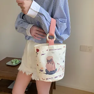 Casual canvas bucket bag for women, cute printed design with pink handle and wooden ring.