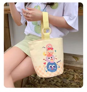 Cute yellow canvas tote bag with wooden ring handle, cartoon print casual handbag for women.