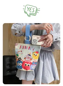 Canvas bucket bag detail featuring cute cartoon monsters print, blue handle, and stylish design.