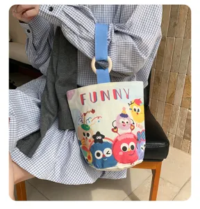 Cute cartoon canvas bucket bag for women, large capacity daily tote, stylish hand-held bag.