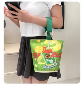Casual green canvas bucket bag with cute cartoon drink print and wooden ring handle daily use.