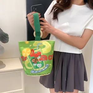 Green canvas bucket bag with cute cartoon drink print, stylish wooden ring handle for women.