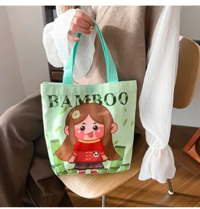 Green canvas tote bag with cute cartoon girl print and bamboo text for daily use.