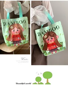 Detailed view of the cute green canvas tote bag featuring a cartoon girl print and sturdy handles.